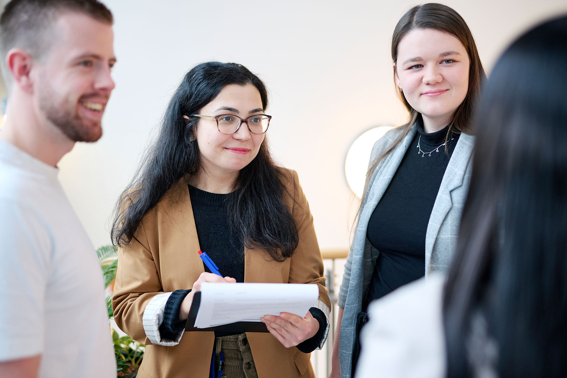 Das Bild zeigt  Kolleginnen und Kollegen im Gespräch.